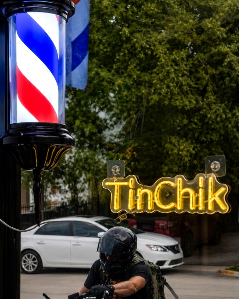 The TinChik sign and barber pole outside the salon on NE 1st Ave in Dania Beach